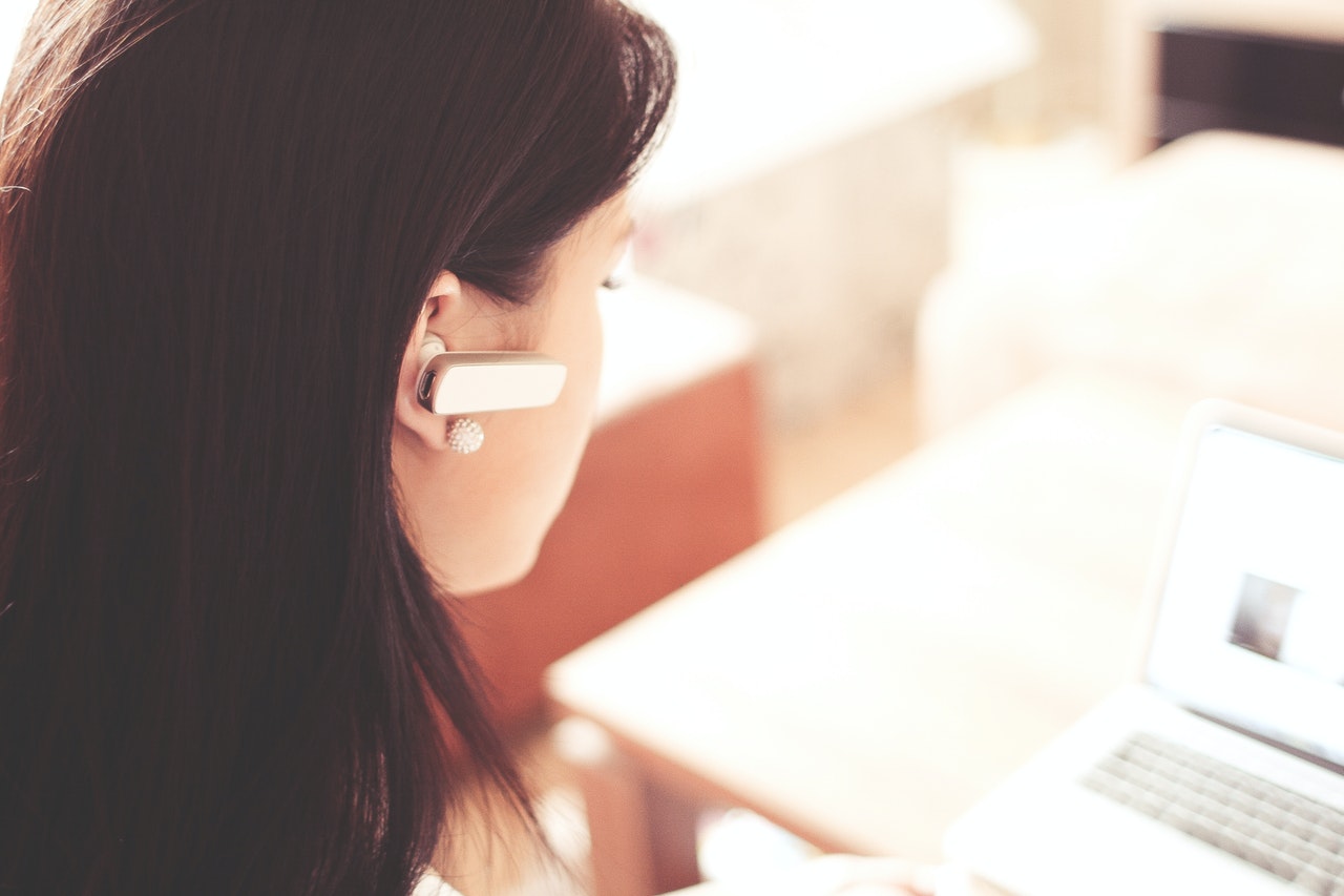 Frau mit Headset im Kundenservice als Remote Job